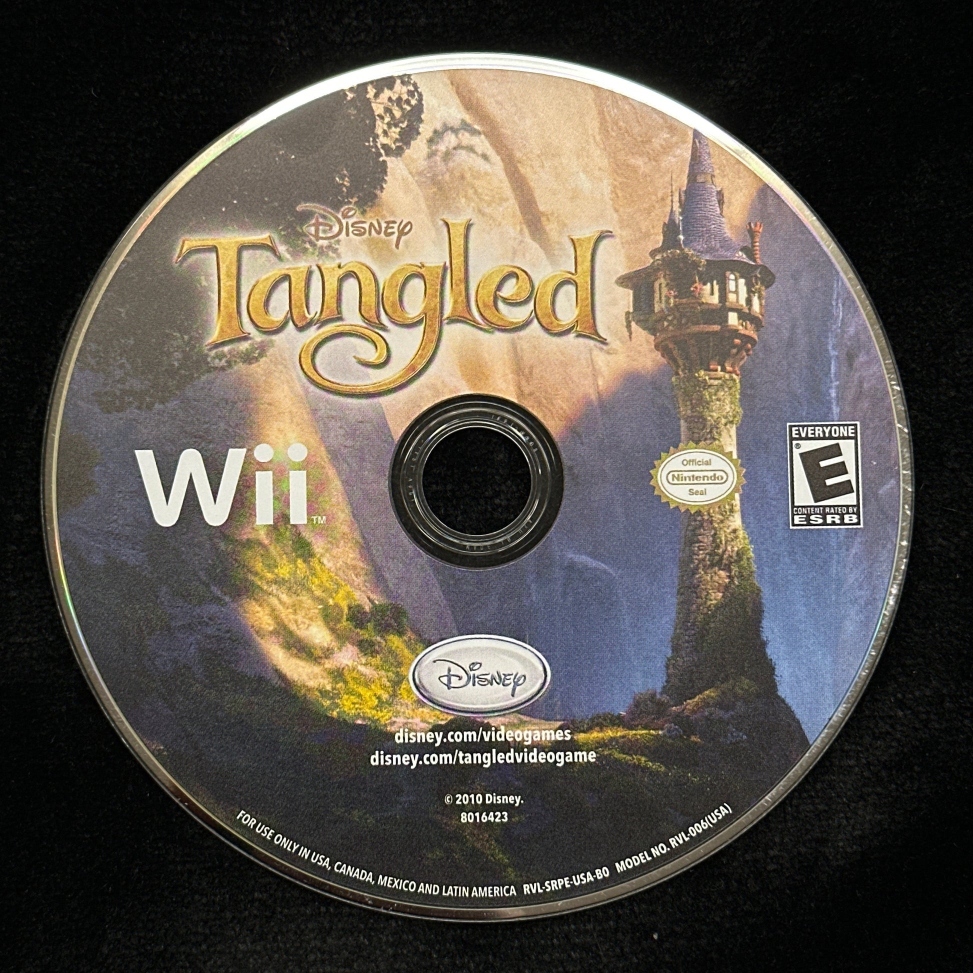 Tangled Wii game disc on a black background