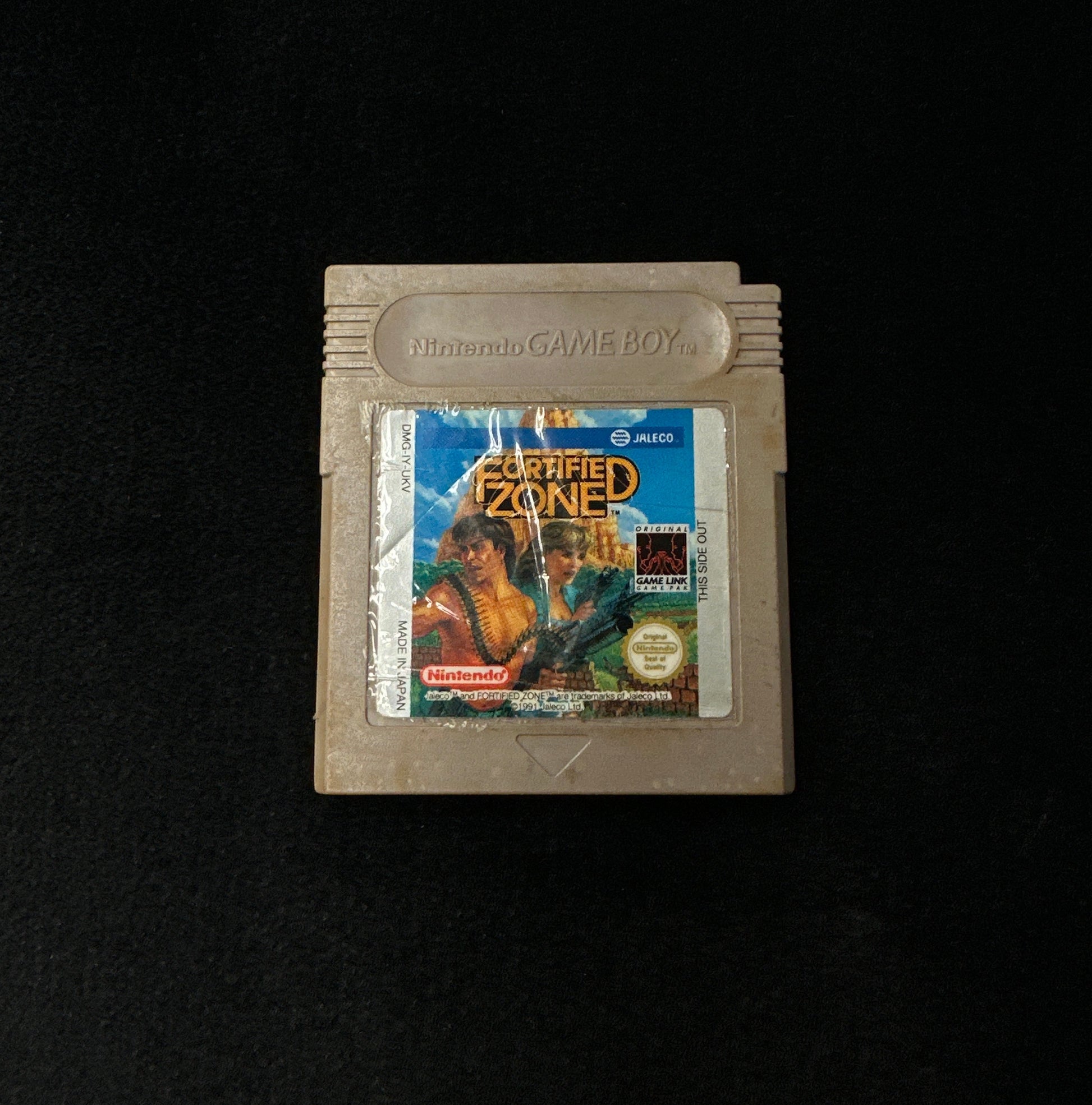 Game cartridge with a label on a black background