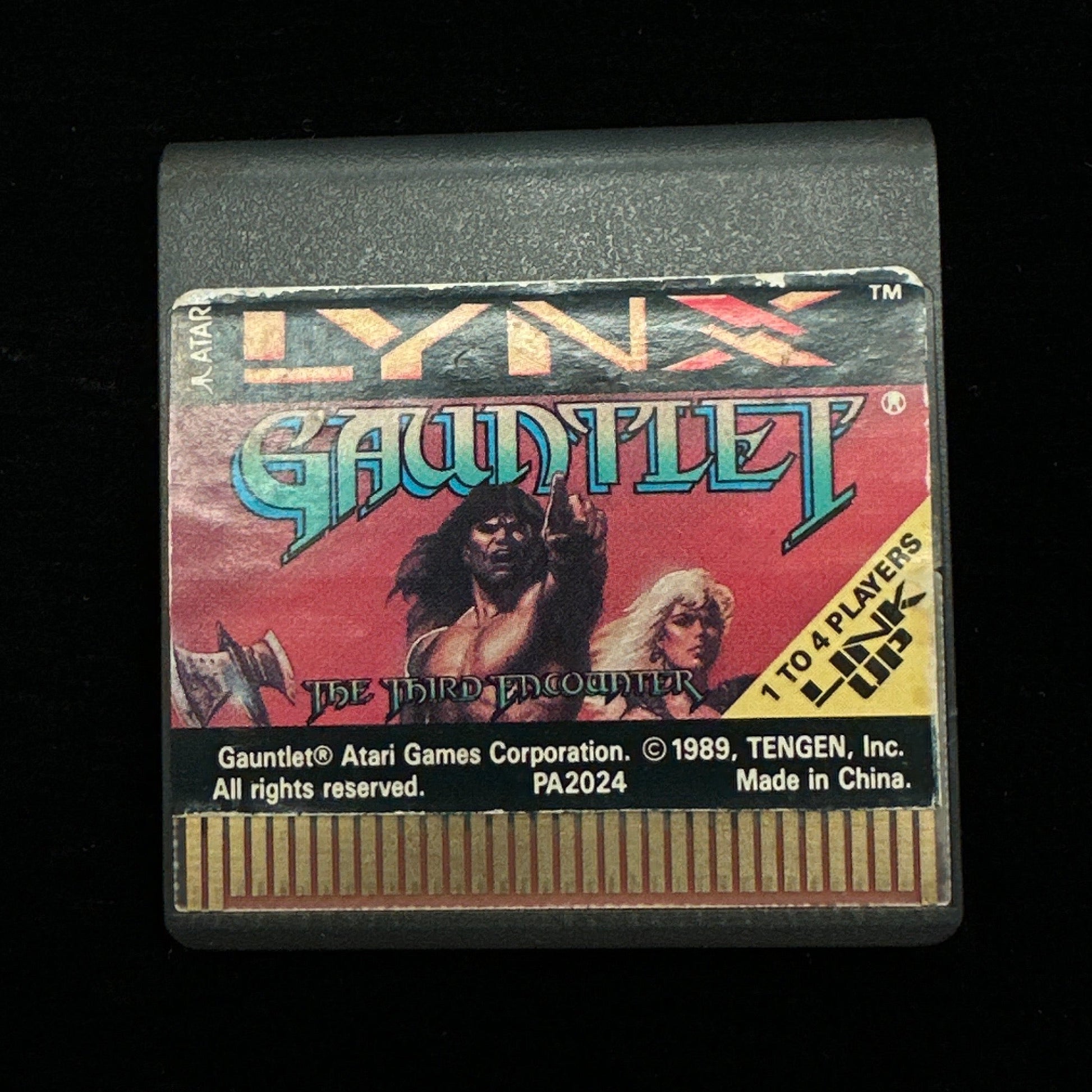 Vintage video game cartridge with colorful label on a black background