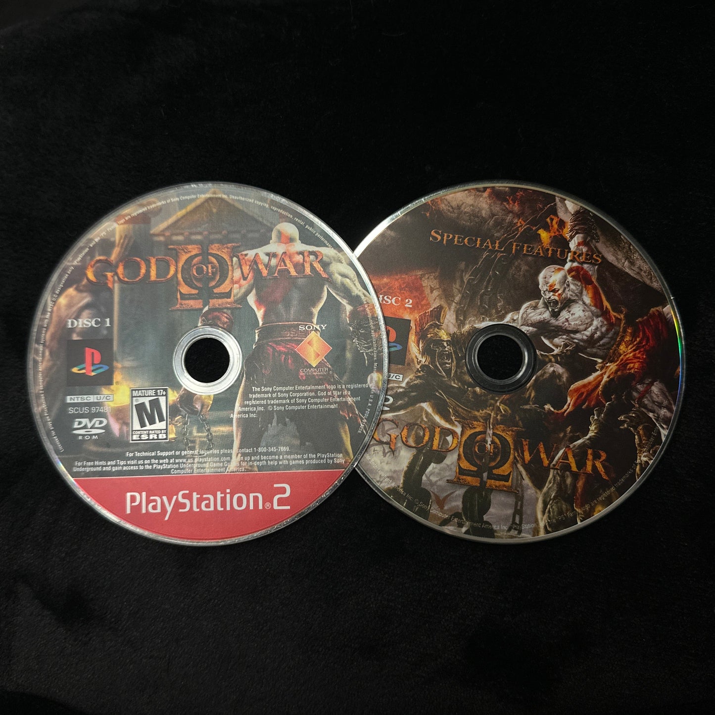 Two game discs for PlayStation 2 on a dark background