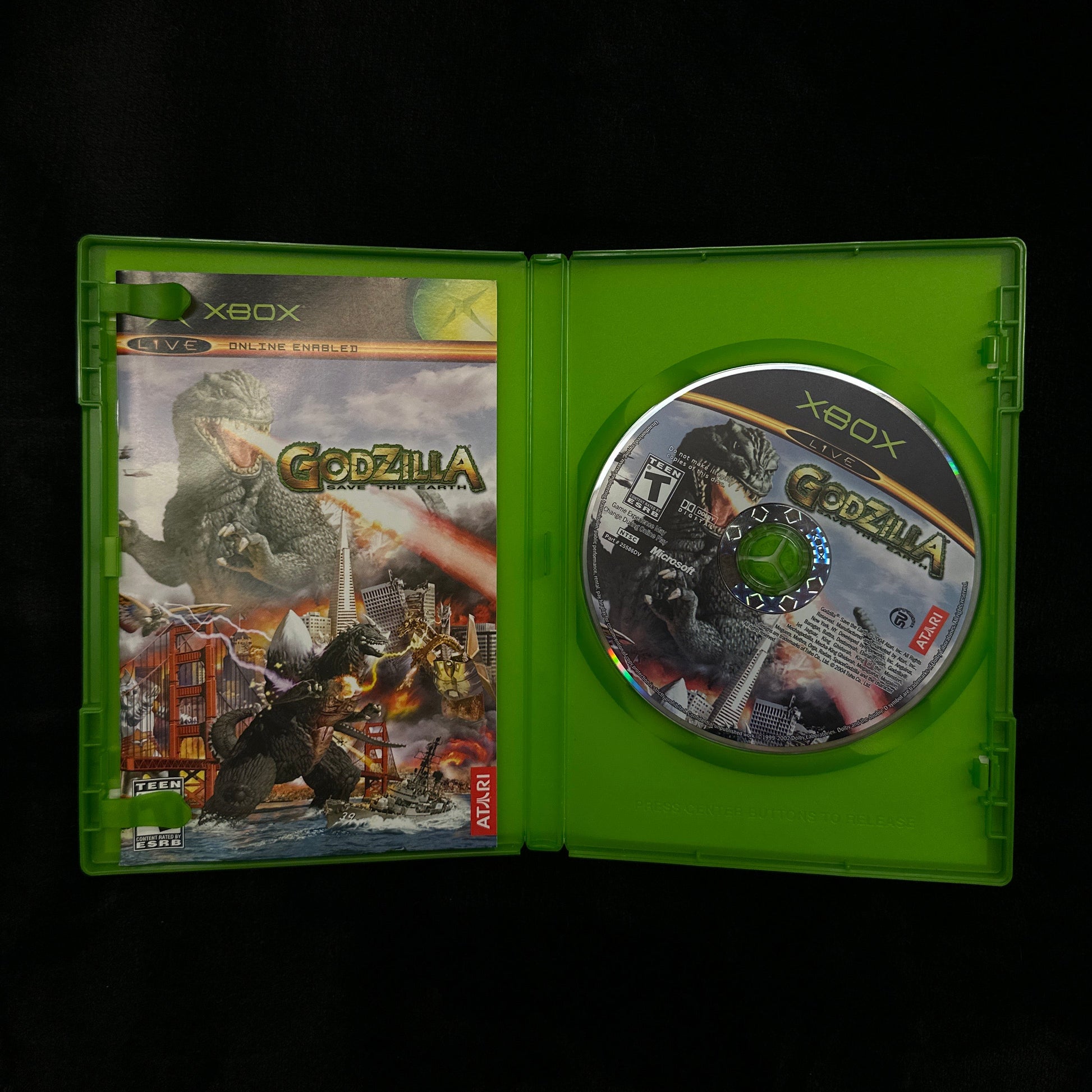 Xbox game disc in a green case on a dark background