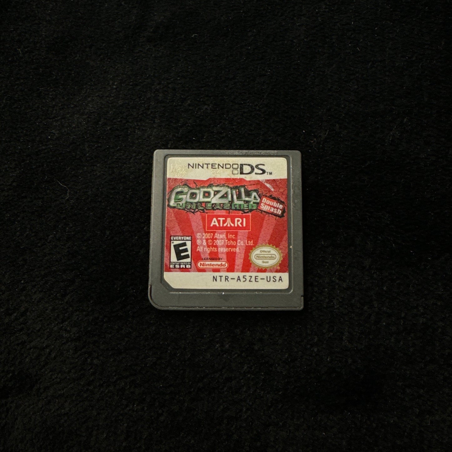 Game cartridge for 'Godzilla' on a black background