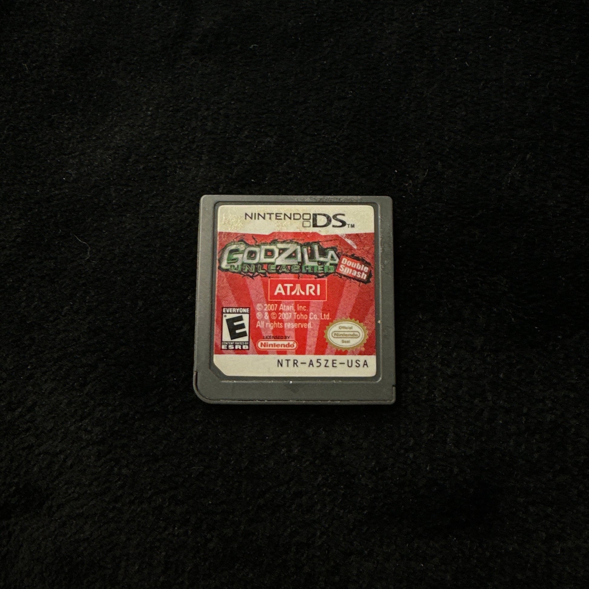 Game cartridge for 'Godzilla' on a black background