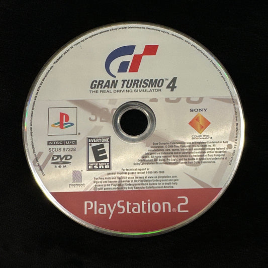 PlayStation 2 game disc with 'Gran Turismo 4' branding on a dark background