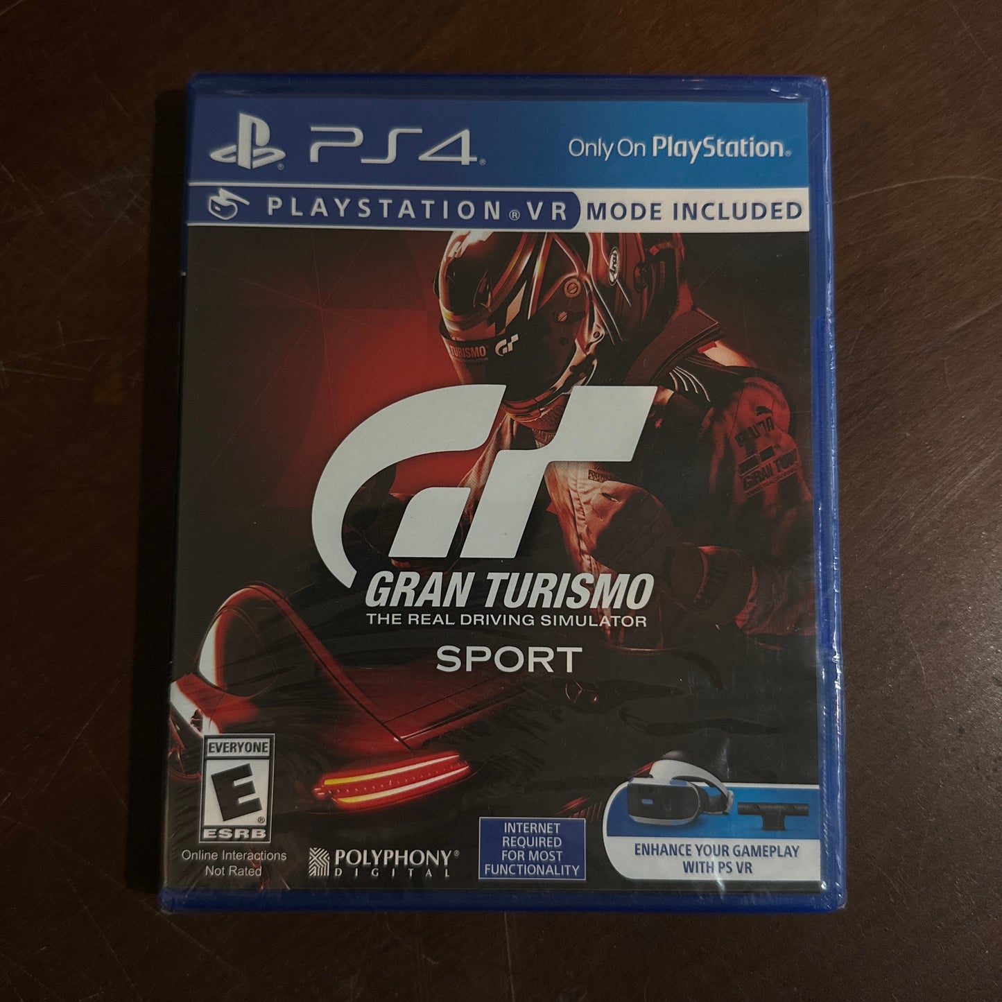 Gran Turismo Sport game box for PlayStation 4 on a wooden surface
