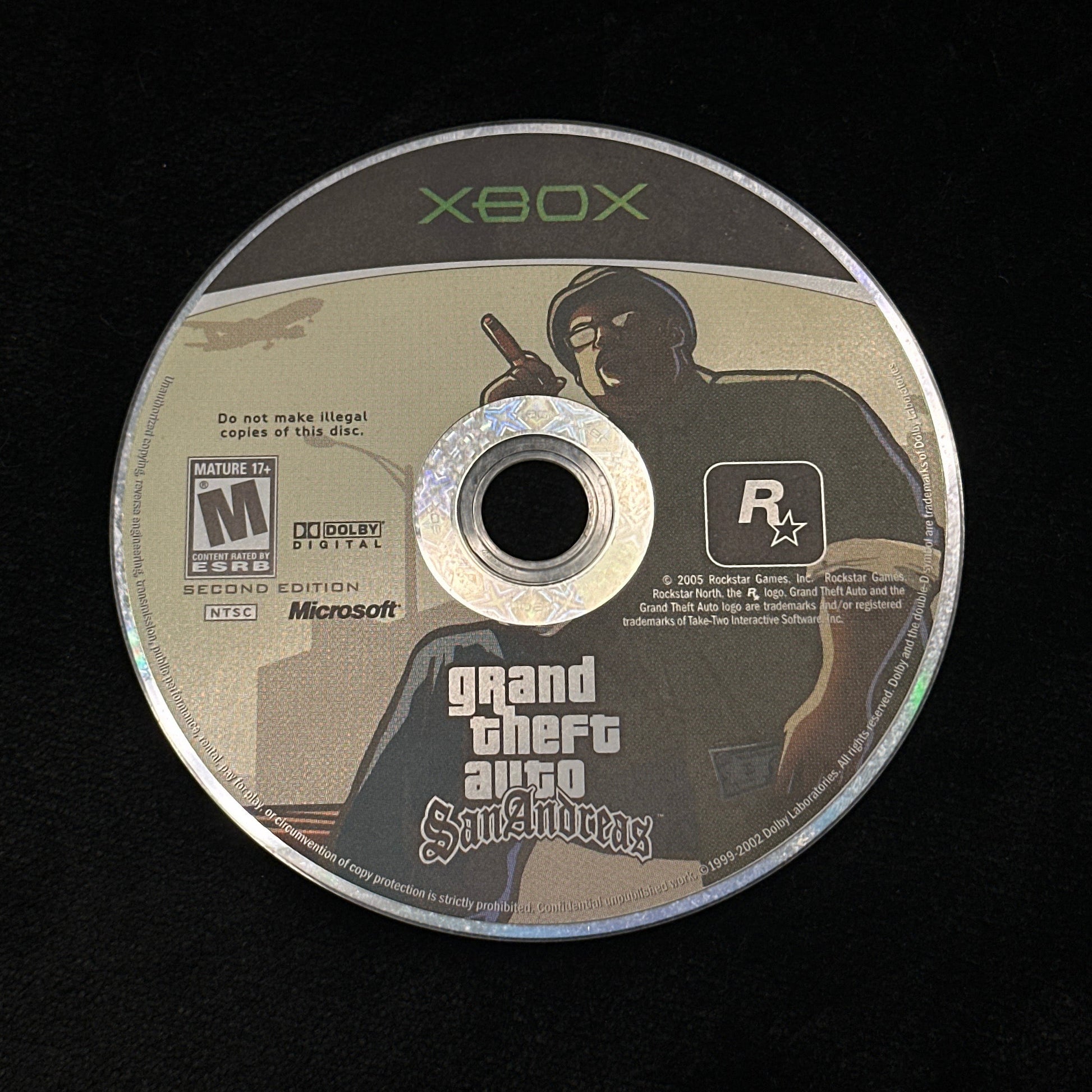 Game disc for Xbox with 'Grand Theft Auto' branding on a black background