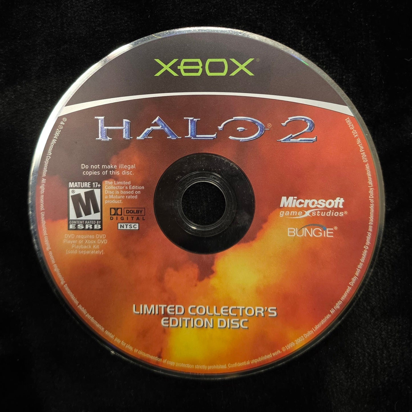 A Halo 2 Limited Collector's Edition Xbox game disc resting on a black fabric surface.