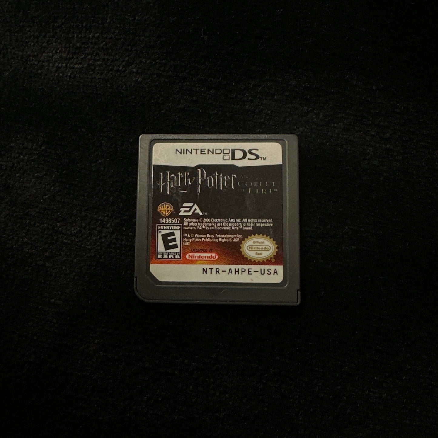 Game cartridge for a handheld gaming console on a dark surface