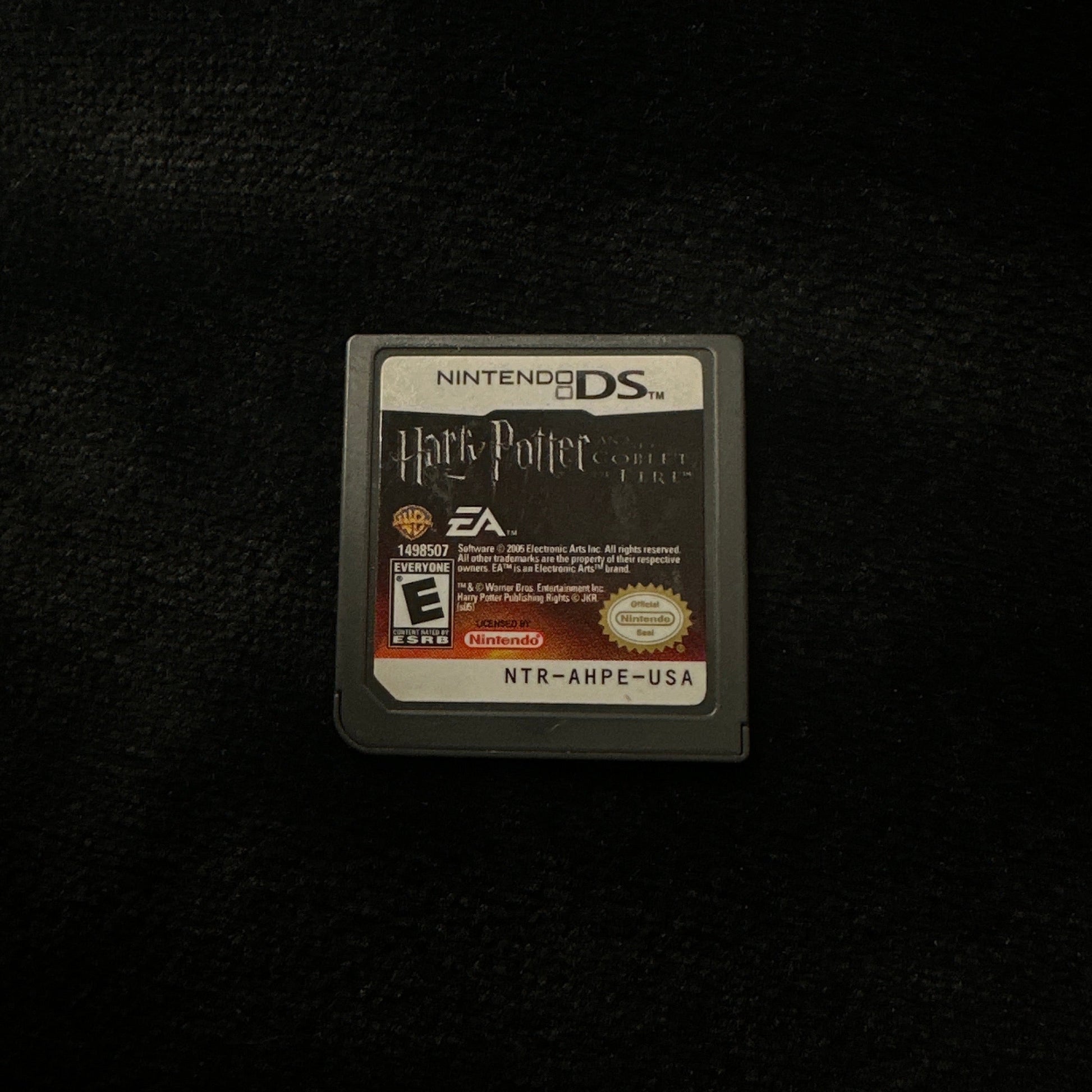 Game cartridge for a handheld gaming console on a dark surface