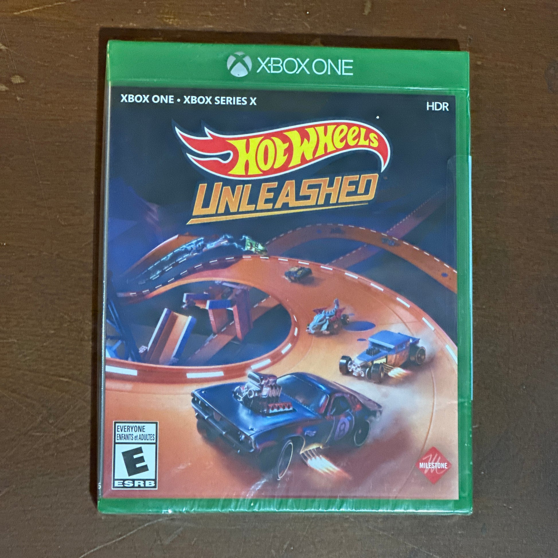Hot Wheels Unleashed game case for Xbox One on a brown surface