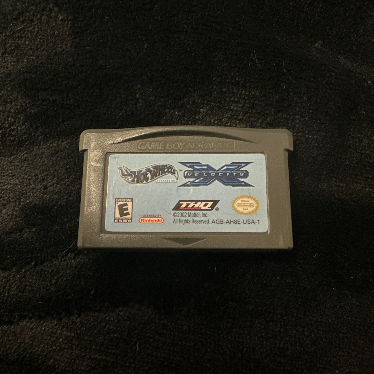 Game cartridge on a dark textured surface