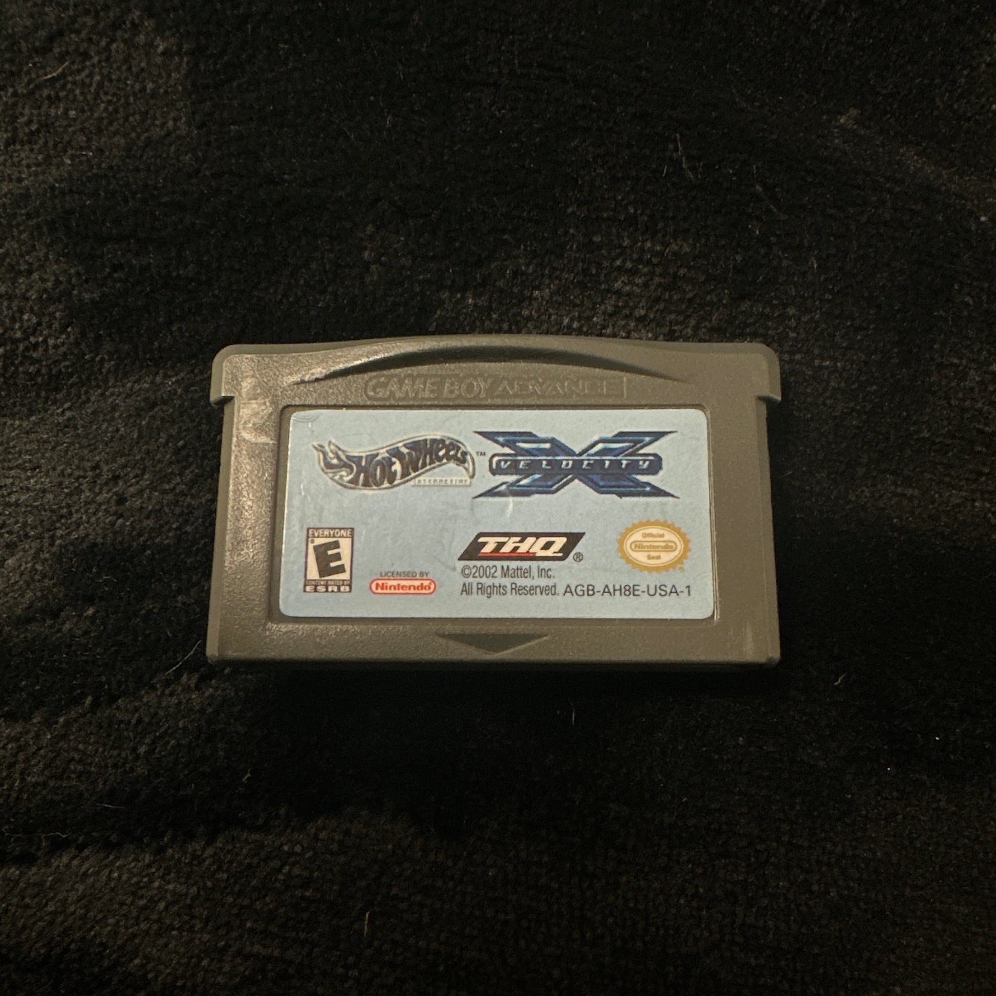 Game cartridge on a dark textured surface