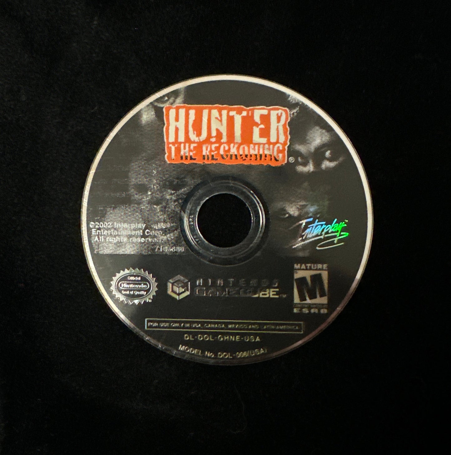 A single Nintendo GameCube game disc for 'Hunter: The Reckoning' resting on a black fabric background.