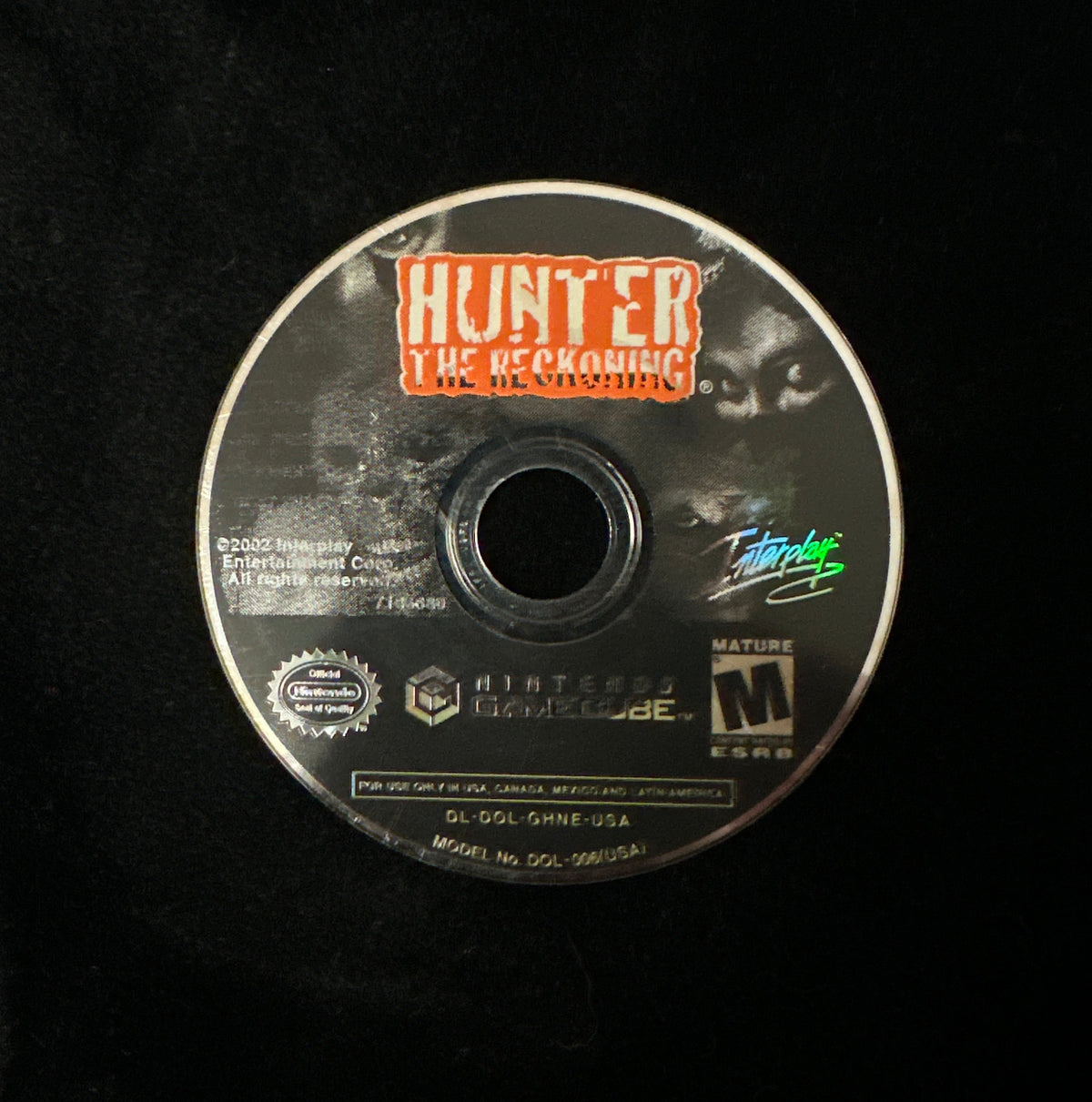 A single Nintendo GameCube game disc for 'Hunter: The Reckoning' resting on a black fabric background.