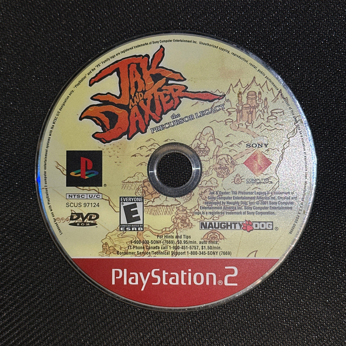 PlayStation 2 game disc with branding and graphics on a dark textured background