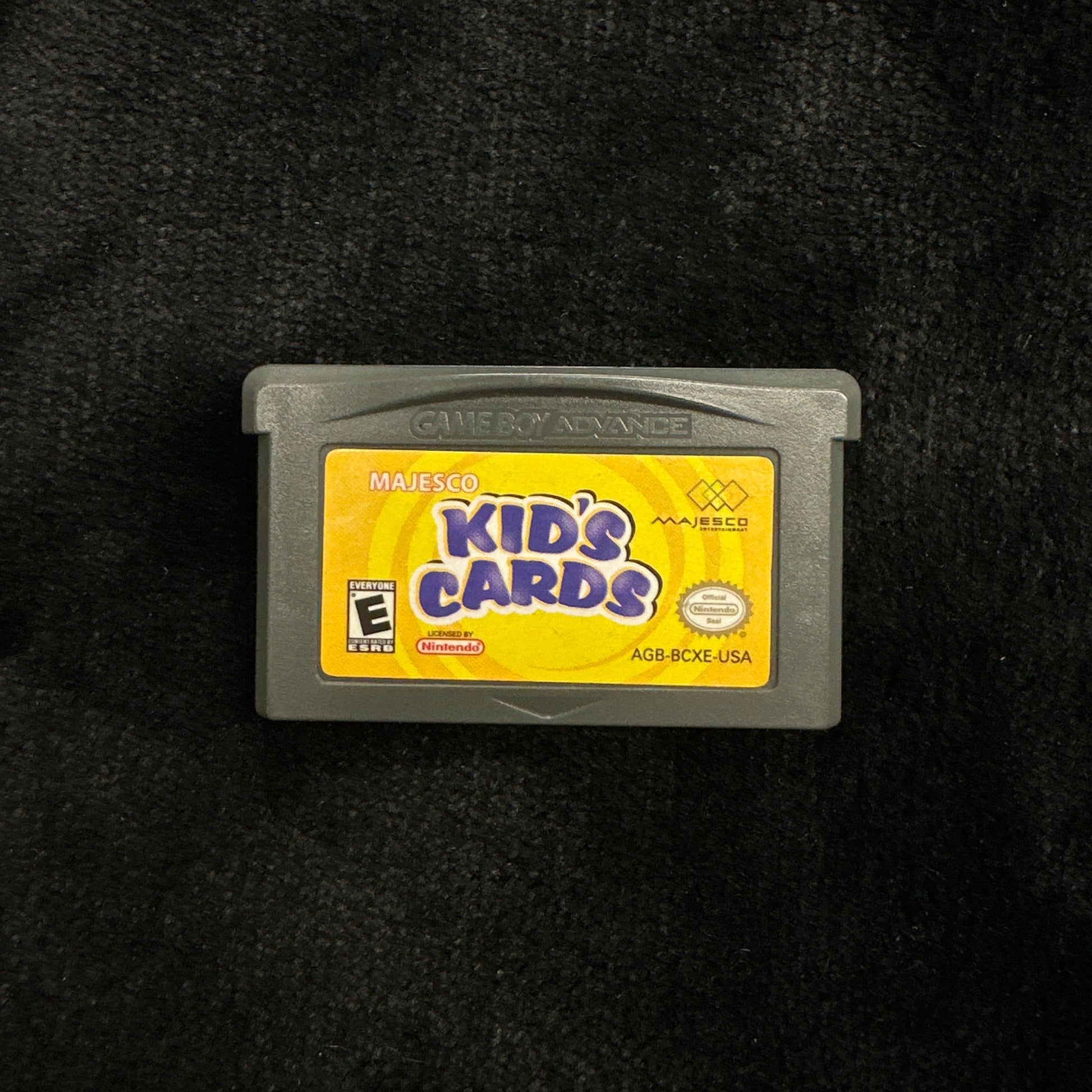 Game cartridge labeled 'Kid's Cards' on a dark background