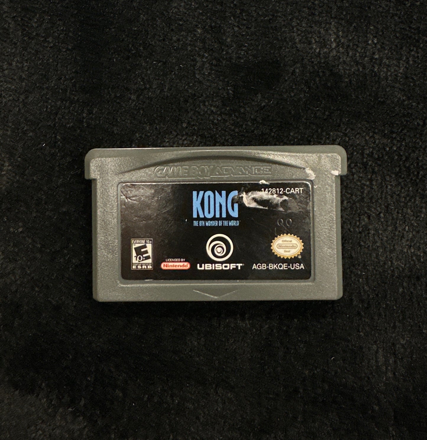 Game cartridge on a dark textured surface