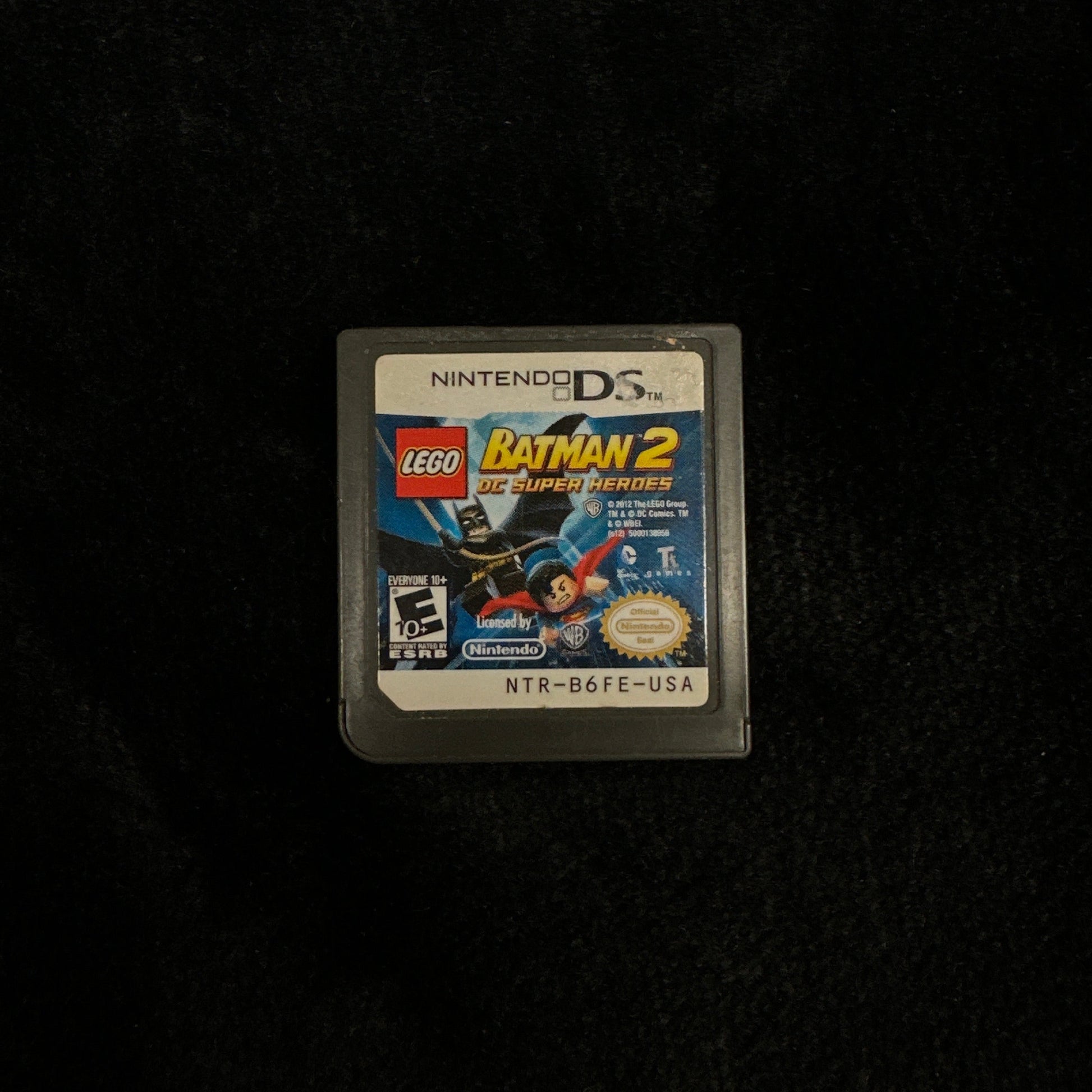 Lego Batman 2 game cartridge on a black background