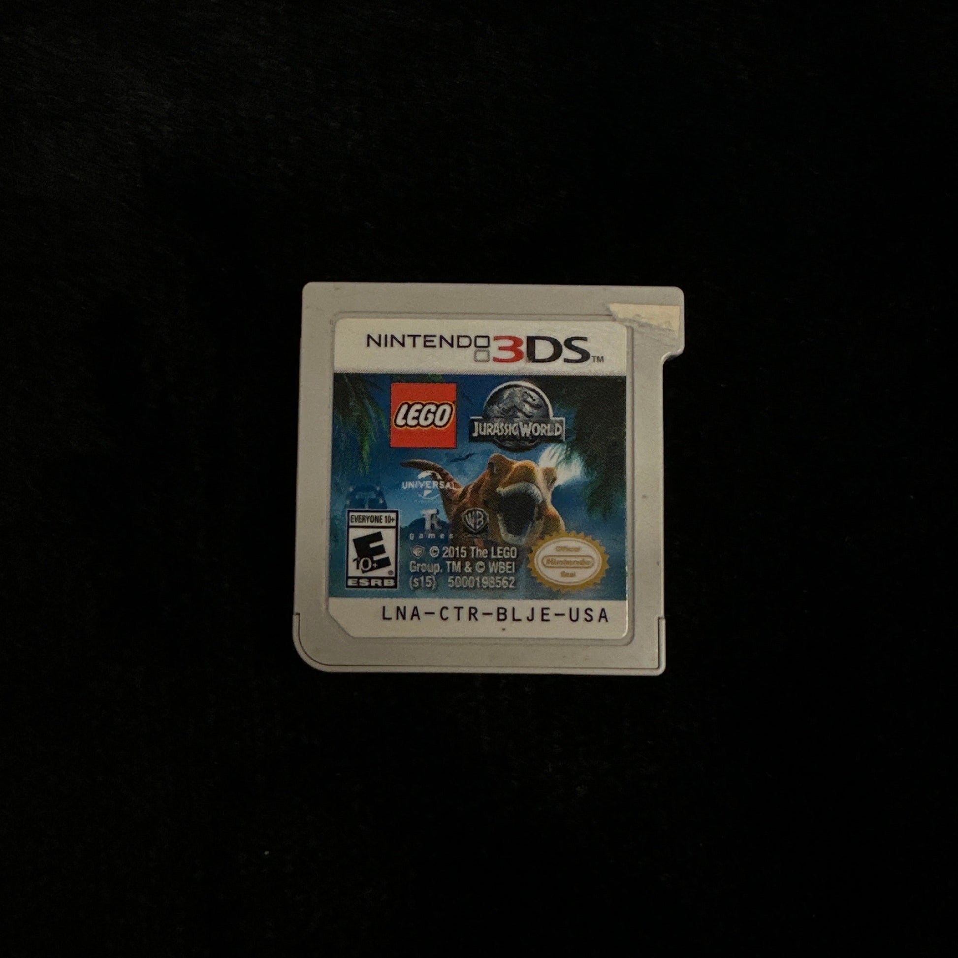 Nintendo 3DS game cartridge with LEGO branding on a dark background