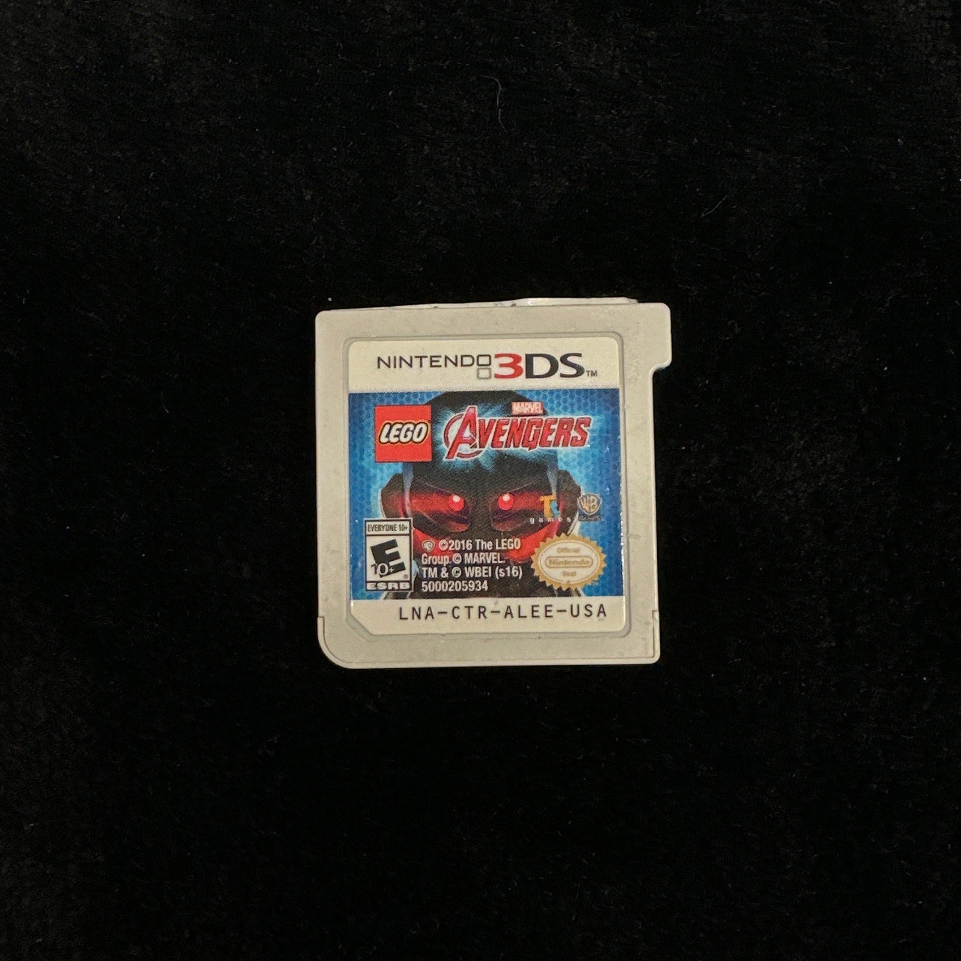 Nintendo 3DS game card with LEGO Avengers branding on a dark background