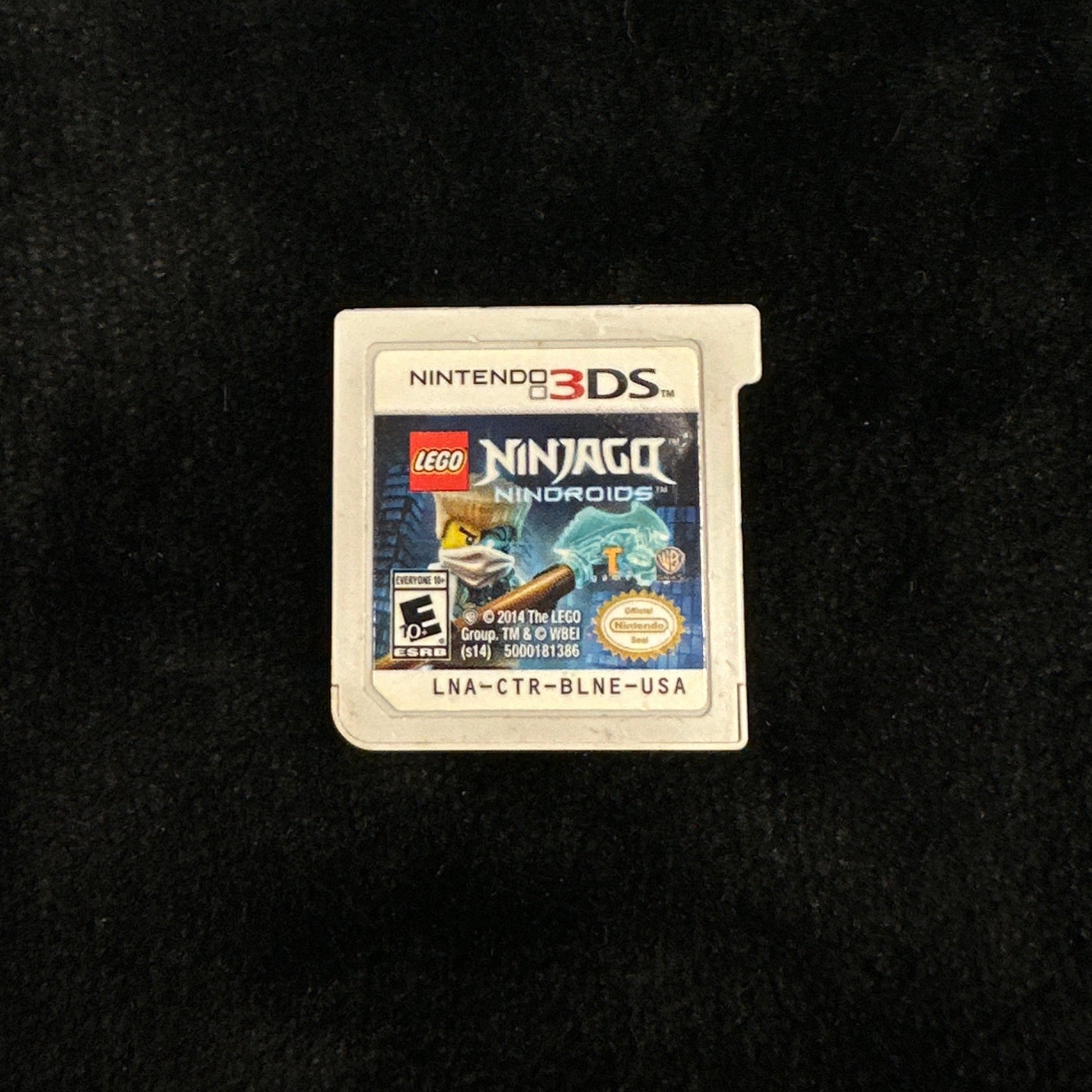Three Nintendo 3DS games on a dark surface