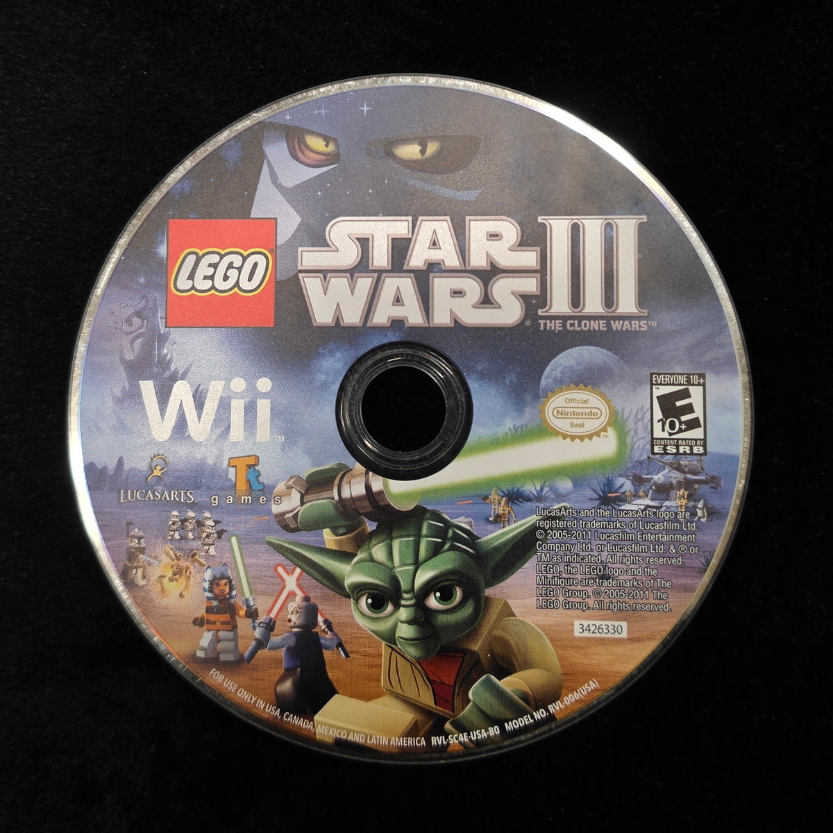 A LEGO Star Wars III Wii game disc resting on a black surface, showing Yoda and other game artwork on the label.