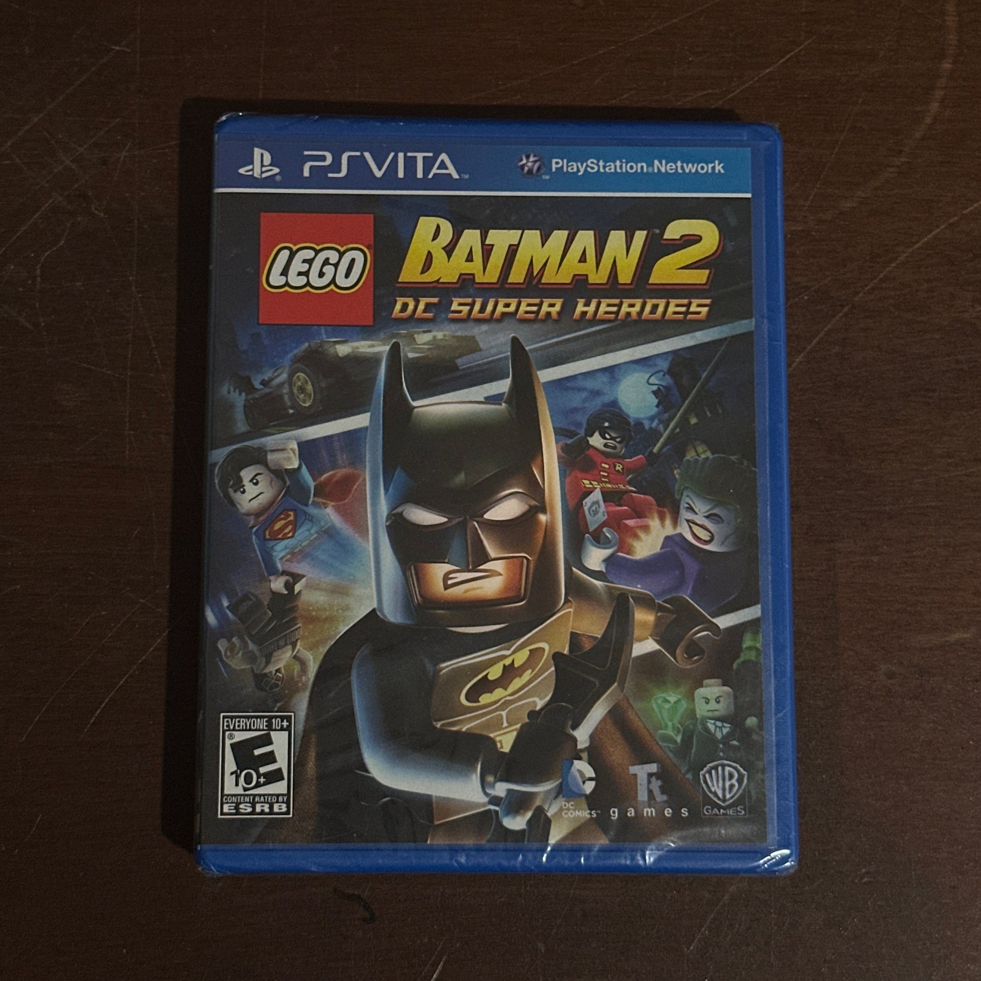 LEGO Batman 2 game case on a brown surface