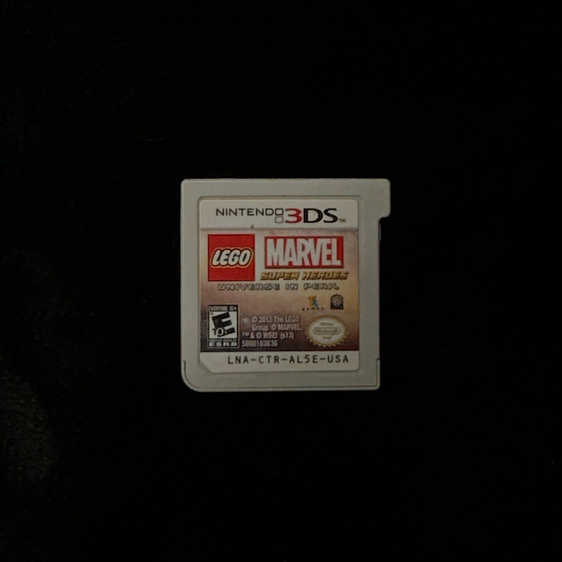 Nintendo 3DS game card with LEGO Marvel branding on a black background