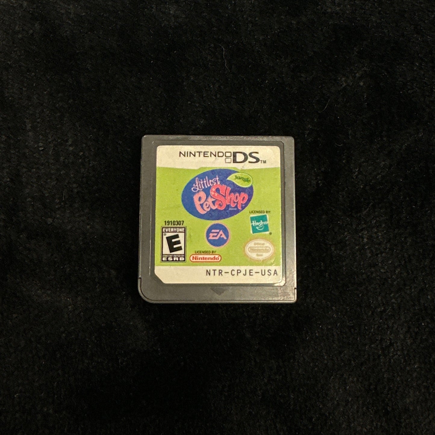 Nintendo DS game cartridge on a dark surface