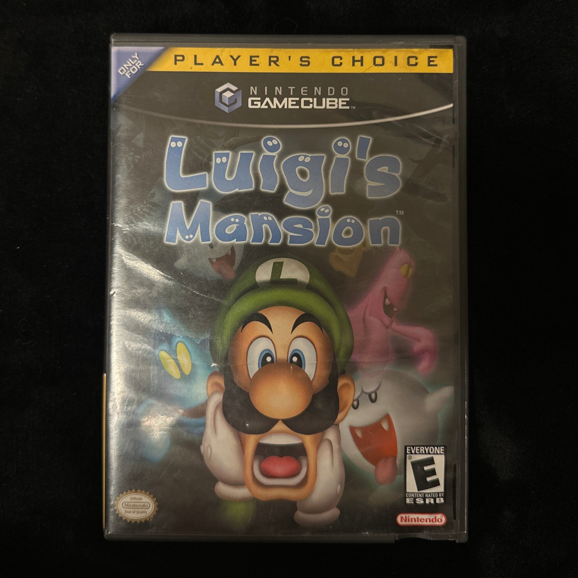 Luigi's Mansion game case for GameCube on a dark background