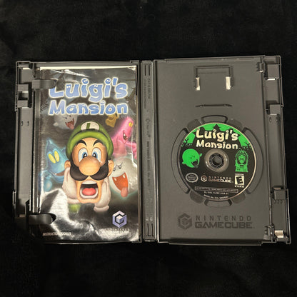 Game case with 'Luigi's Mansion' on a dark surface