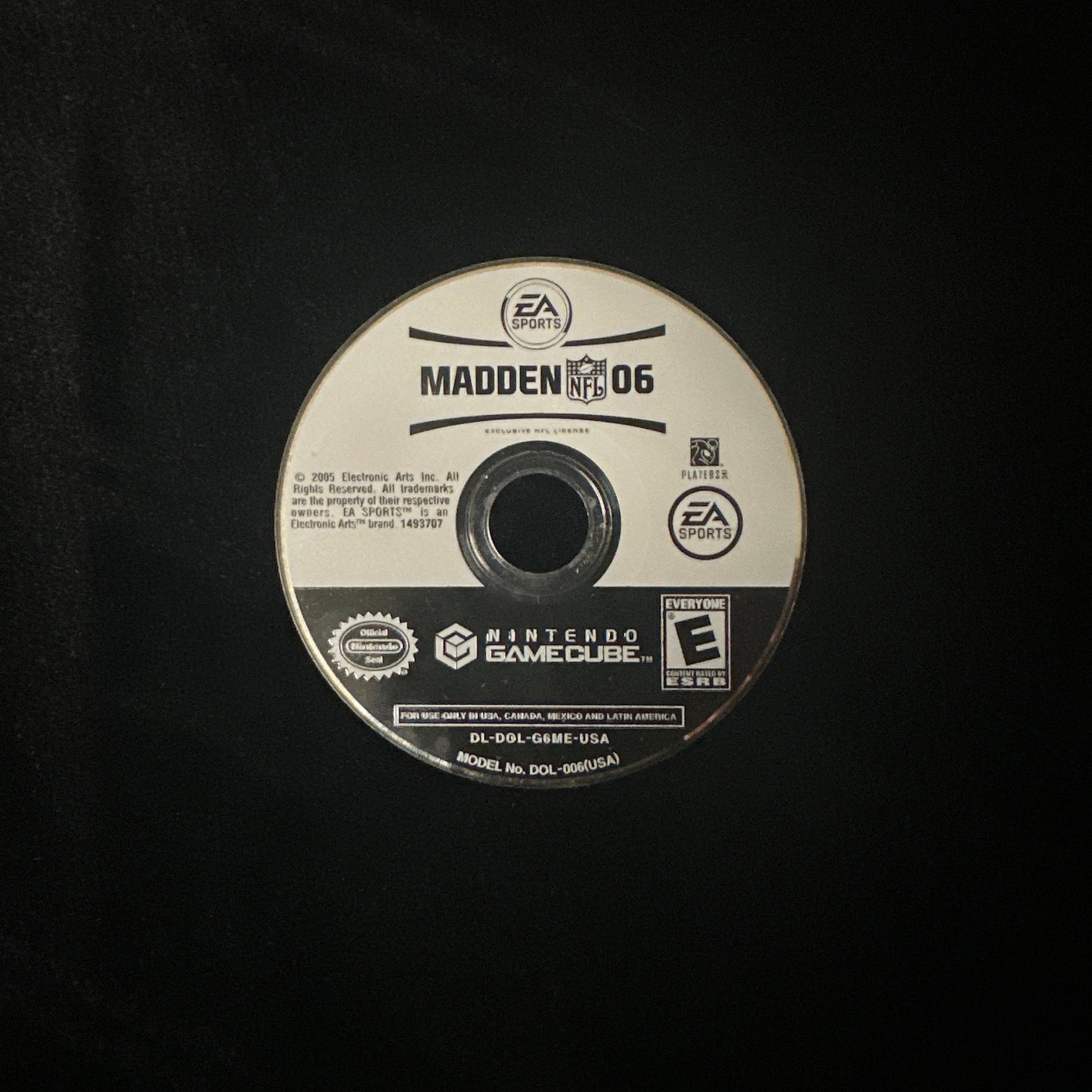 A single PlayStation 2 game disc for Madden 06 on a black background.