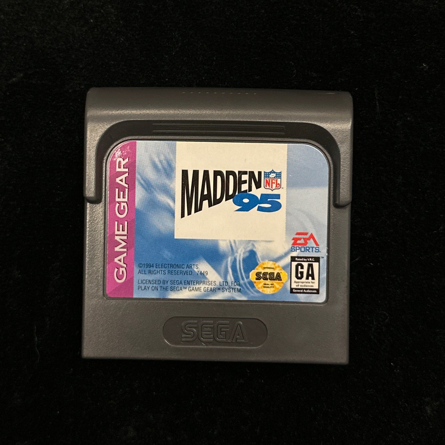 Sega Game Gear cartridge of 'Madden 95' on a black background