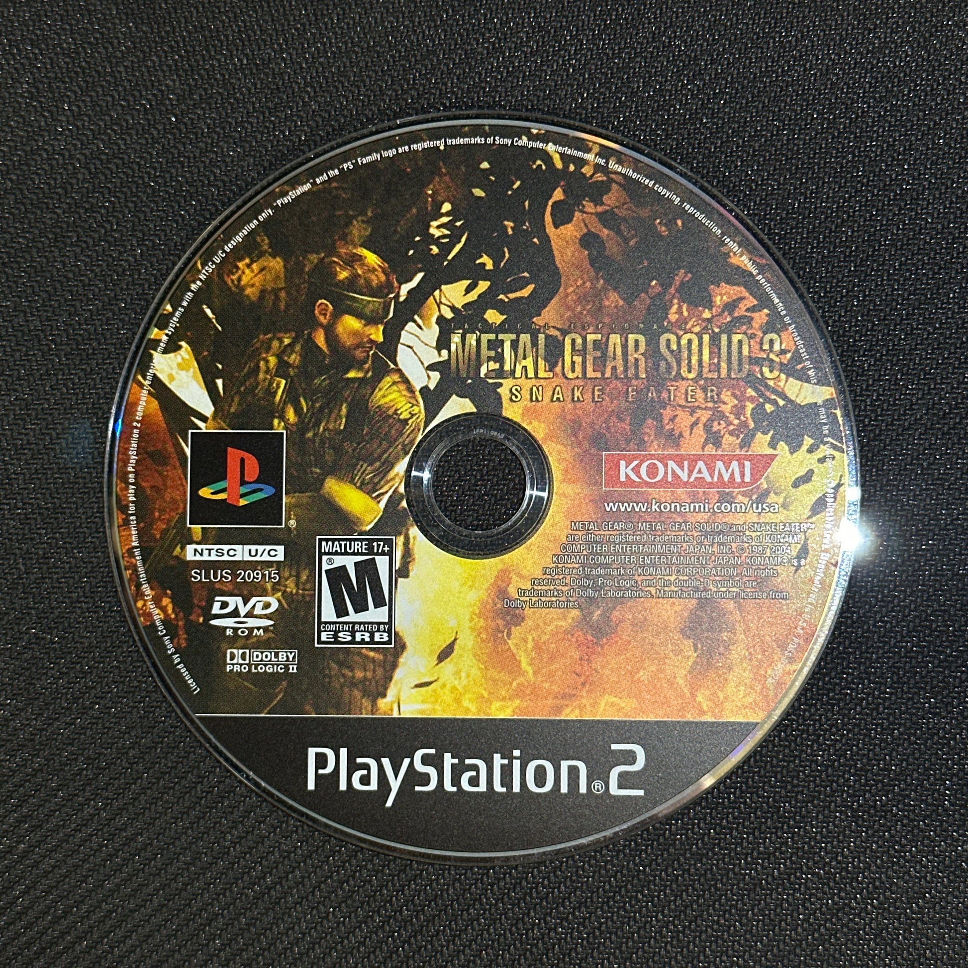 PlayStation 2 game disc with Konami branding on a textured black surface