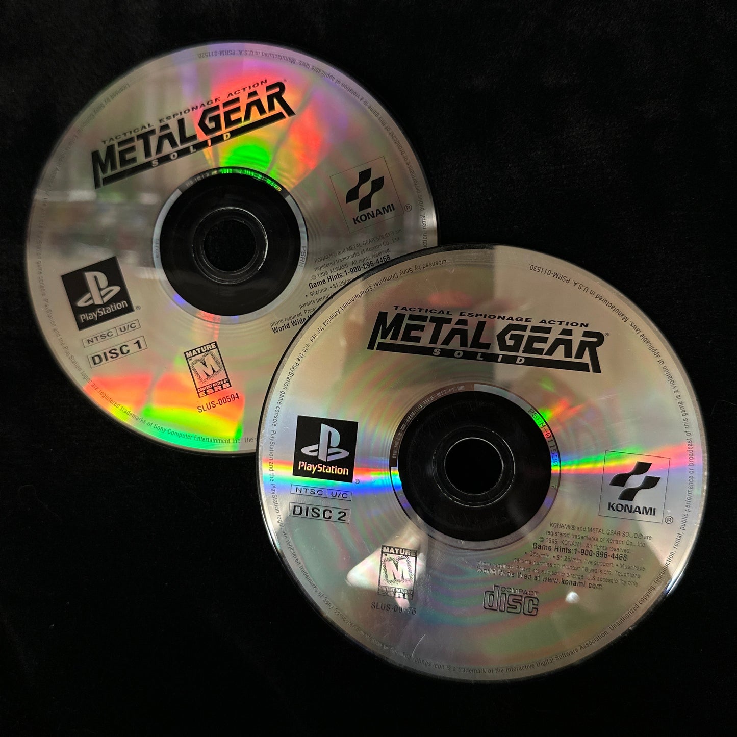 Two 'Metal Gear' game discs on a black background