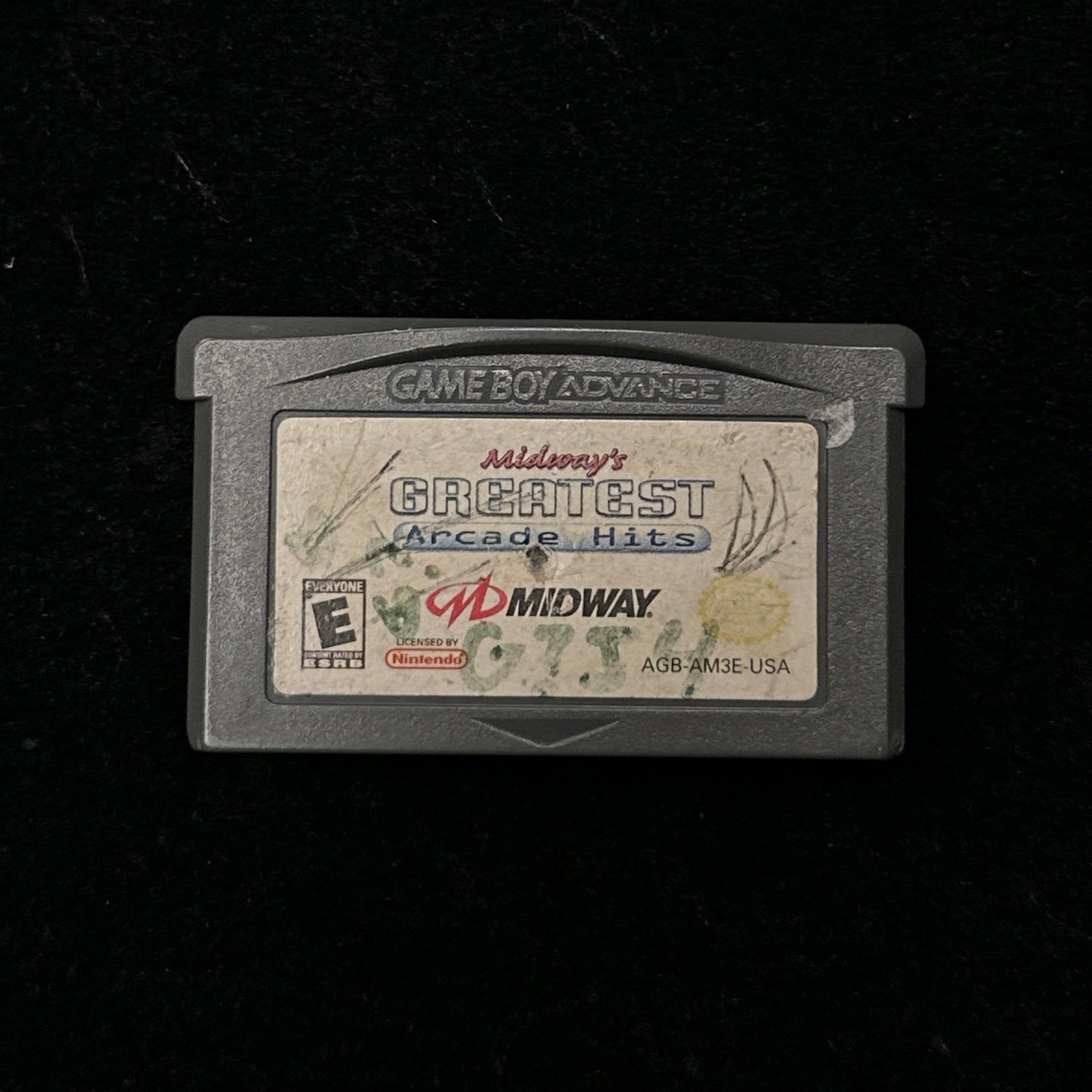 Game cartridge with 'Midway's Greatest Arcade Hits' label on a black background