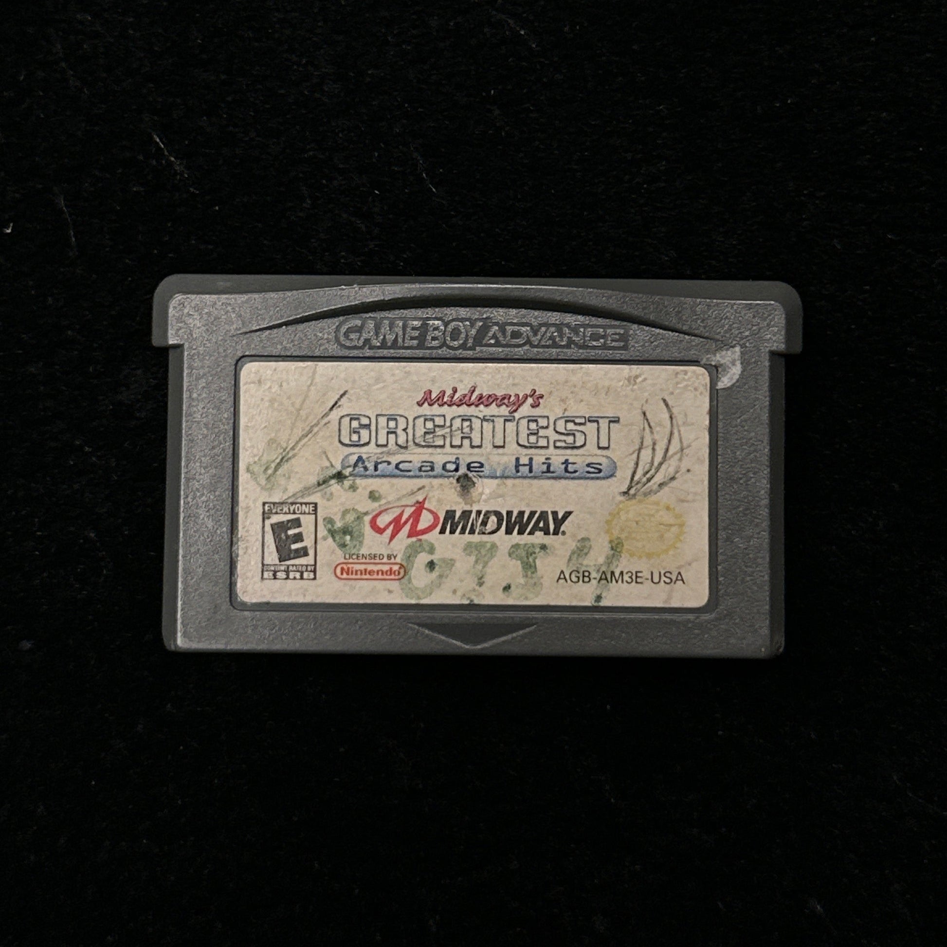 Game cartridge with 'Midway's Greatest Arcade Hits' label on a black background