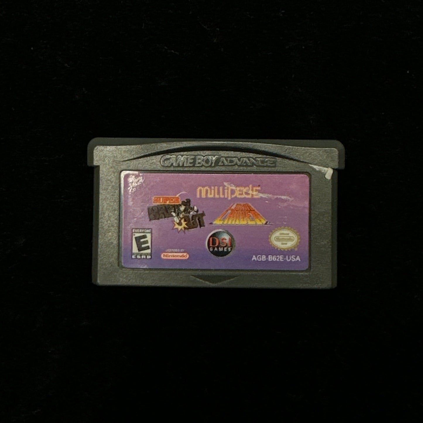Game cartridge with a purple label on a black background