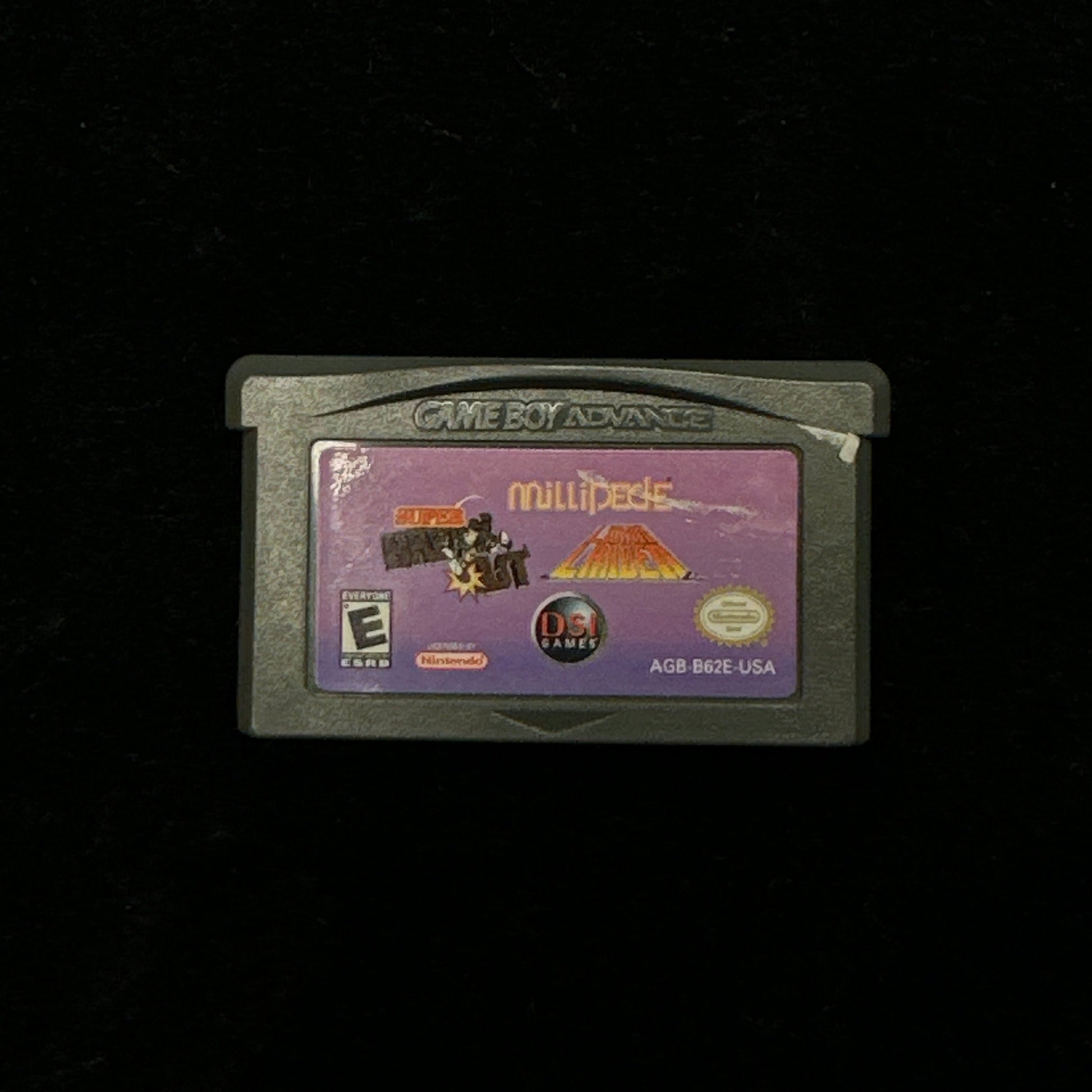 Game cartridge with a purple label on a black background