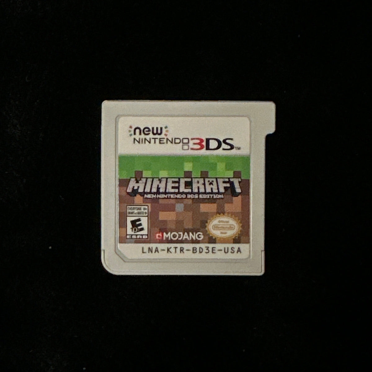 Nintendo 3DS Minecraft game cartridge on a black background.