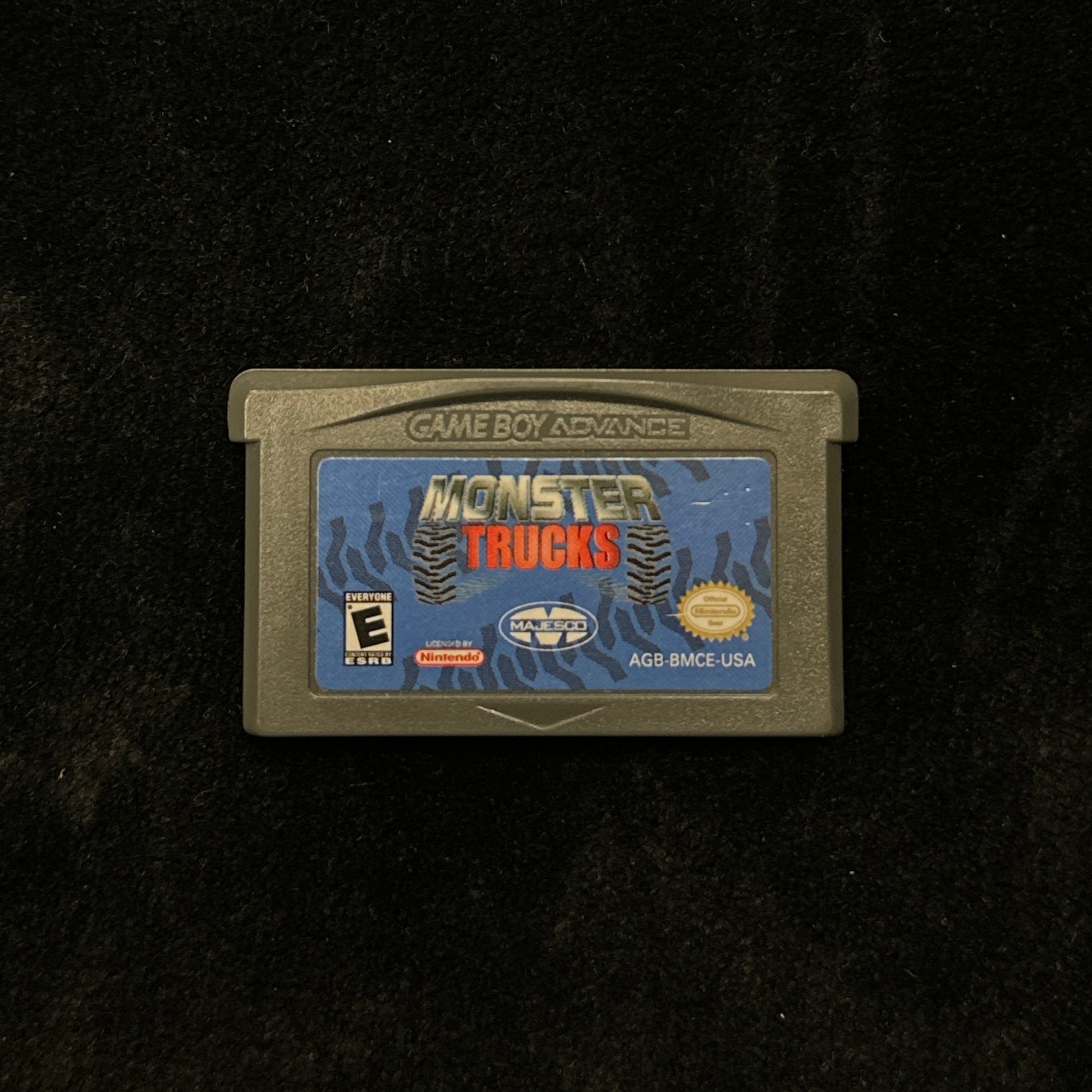 Game cartridge for 'Monster Trucks' on a black background
