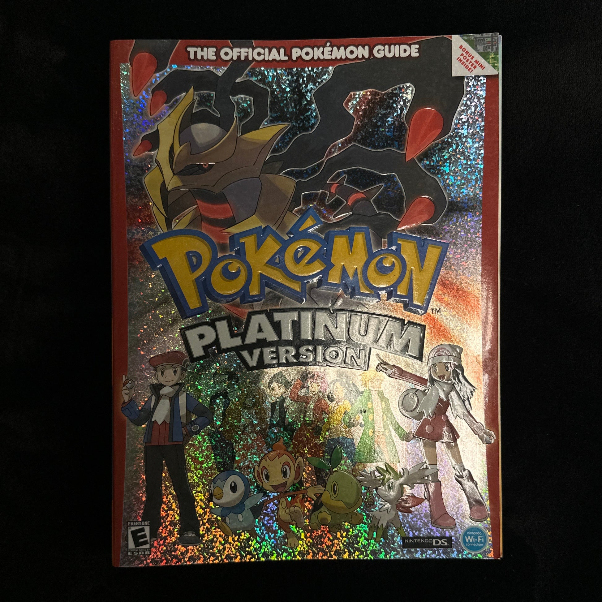 Pokémon guide book titled 'Pokémon Platinum Version' held by a person.