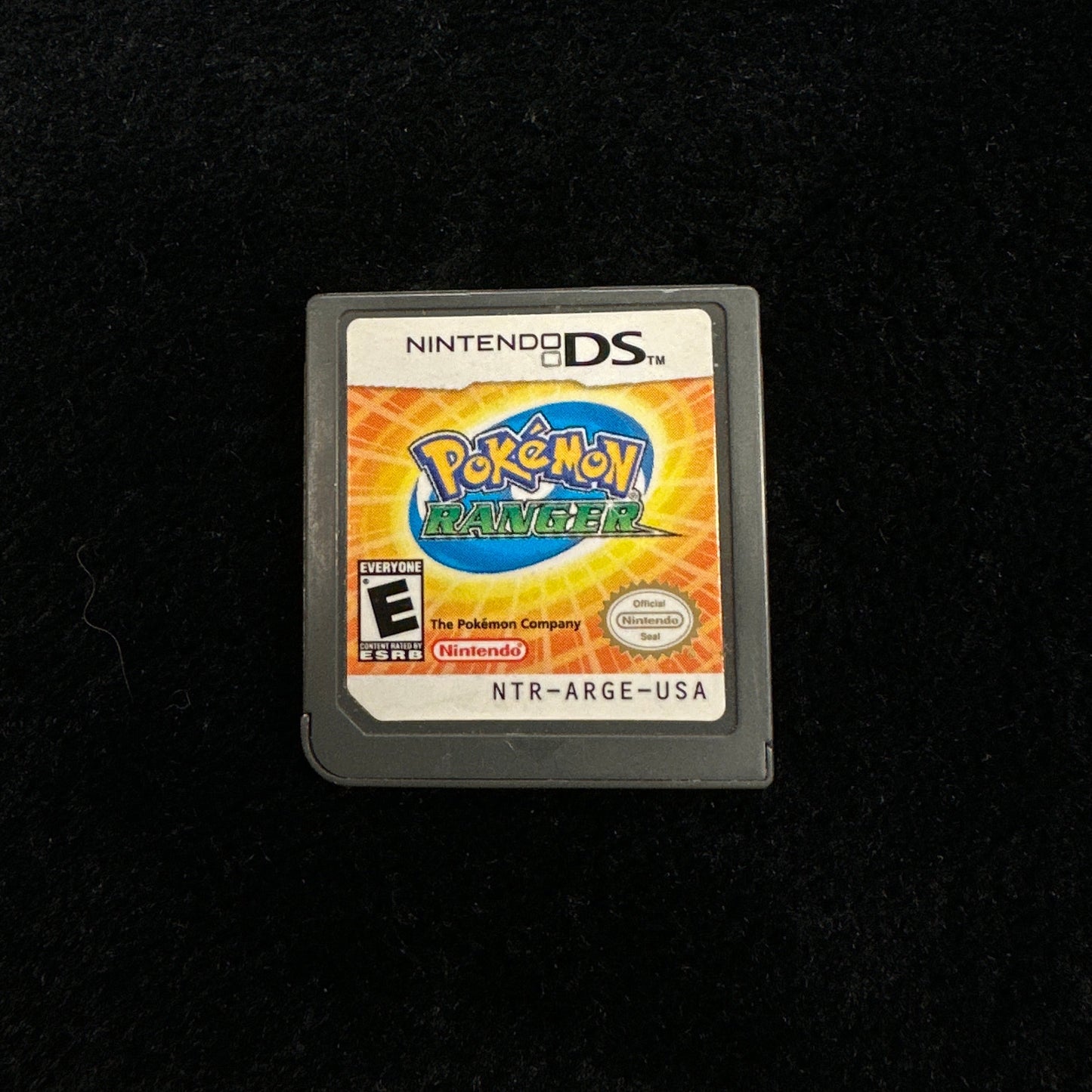 Pokémon game cartridge on a black background