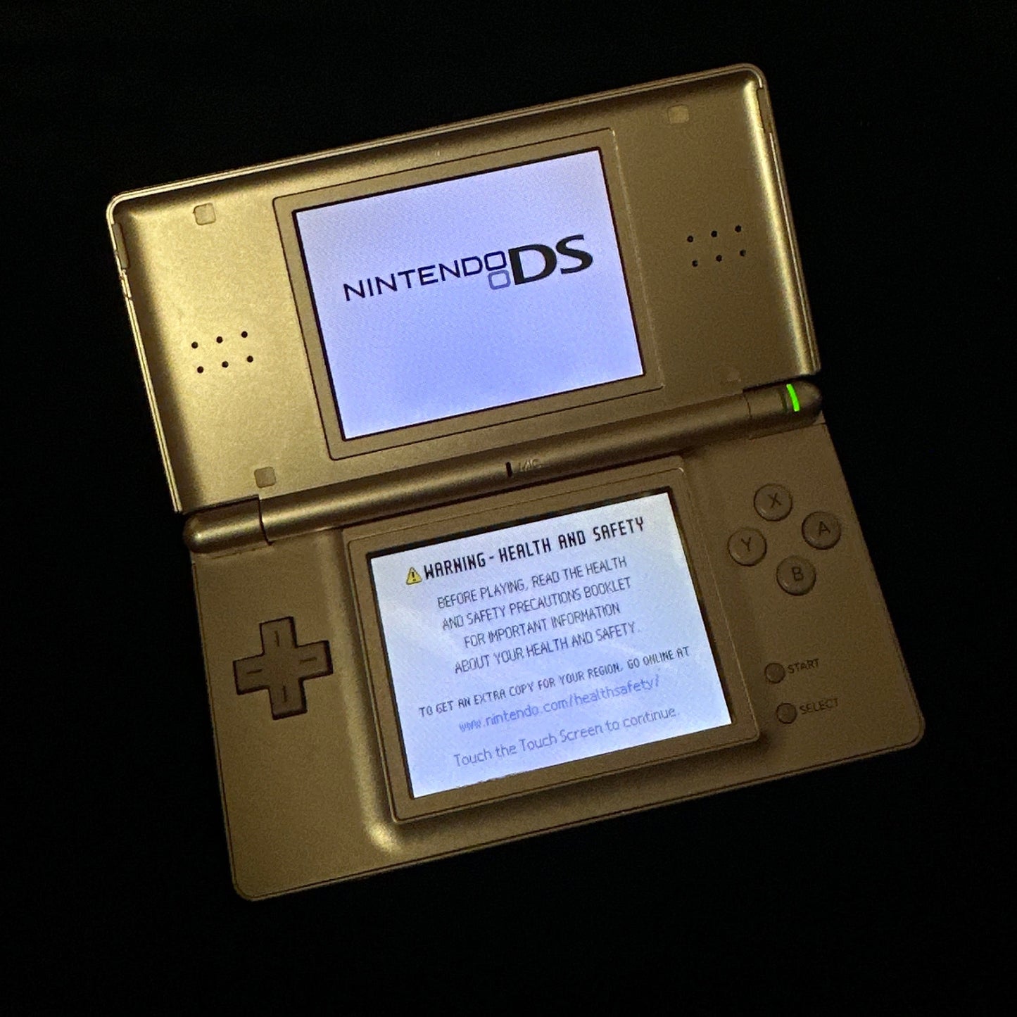 Rose Gold Nintendo DSi Lite open on