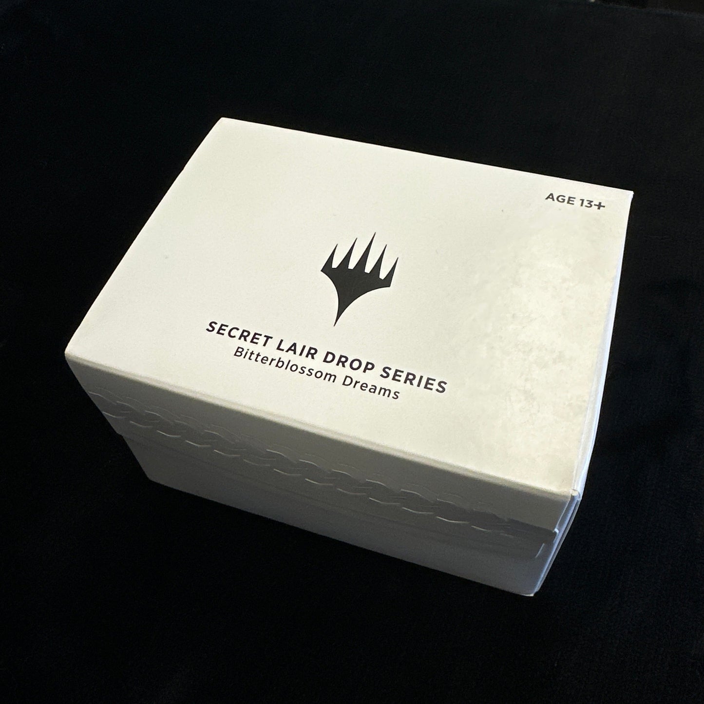 White box with a MTG logo and text on a black background