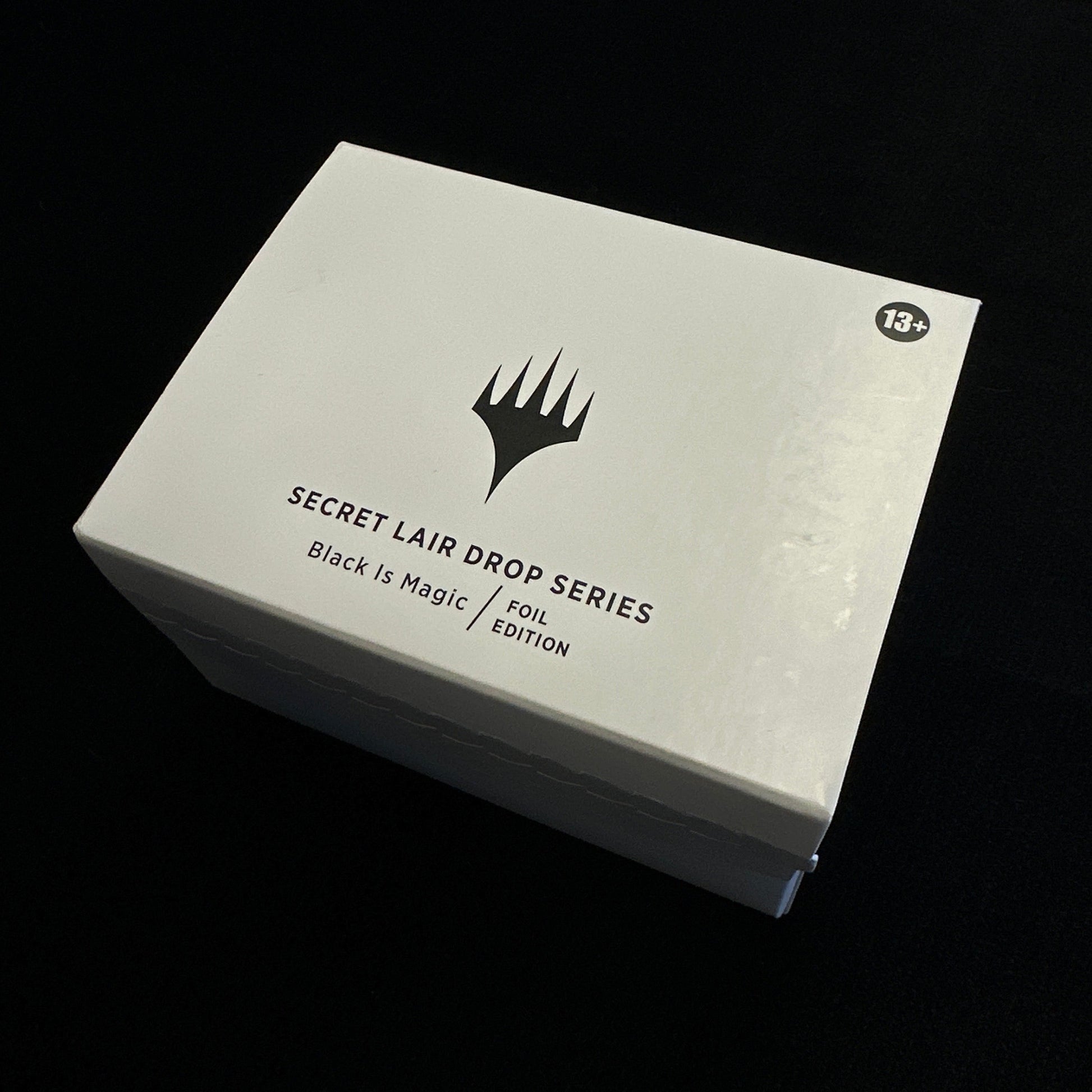 White box with black text and MTG logo on a dark background