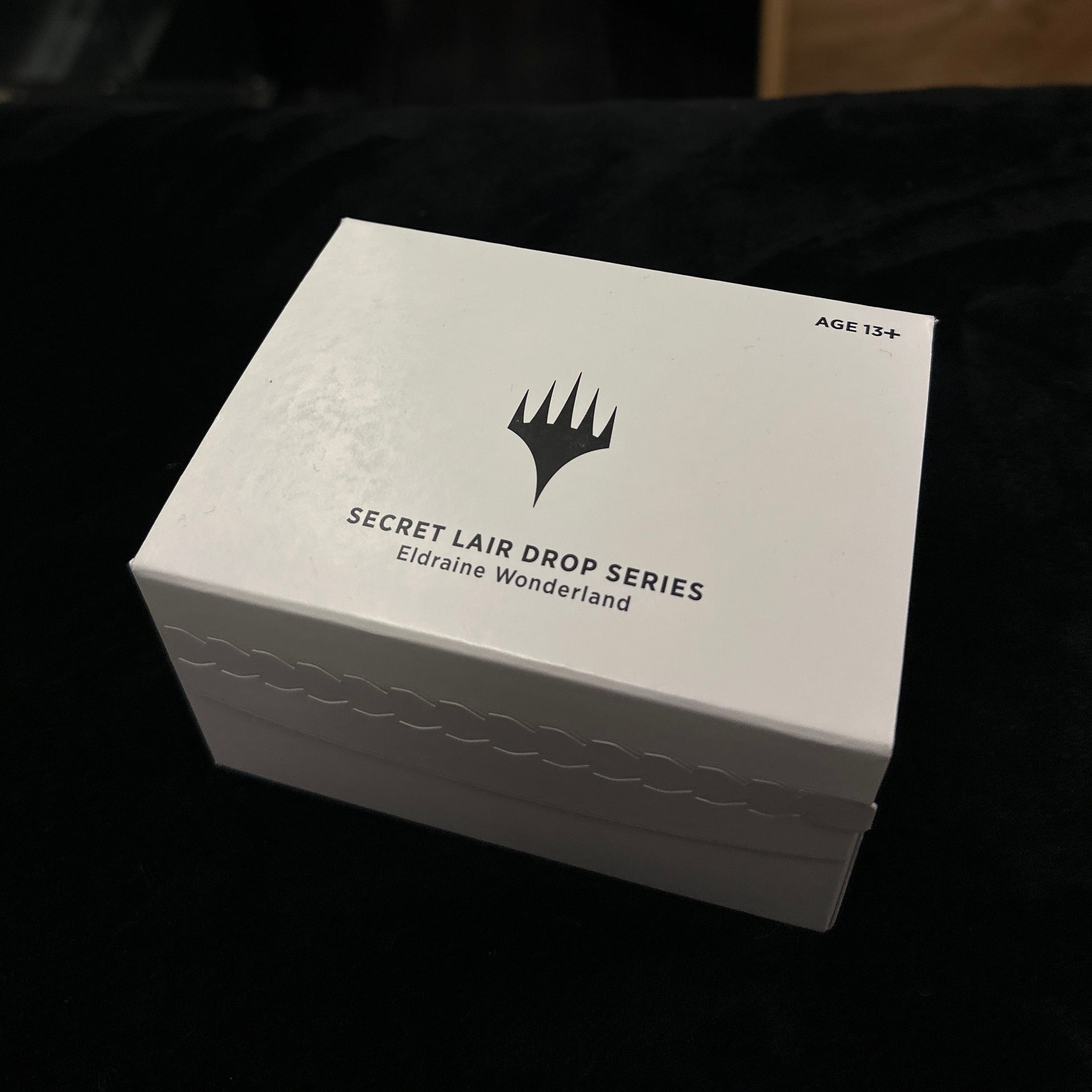 White box with mtg branding on a dark background
