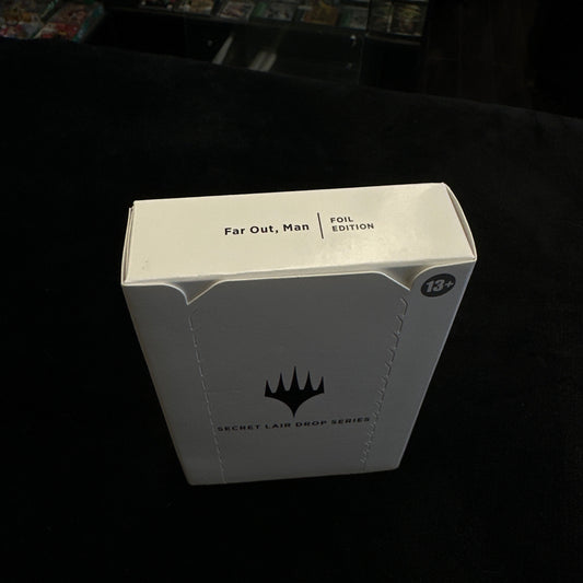 White product packaging with black text and mtg logo on a dark background
