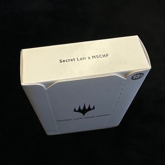 White product packaging with mtg branding on a black background