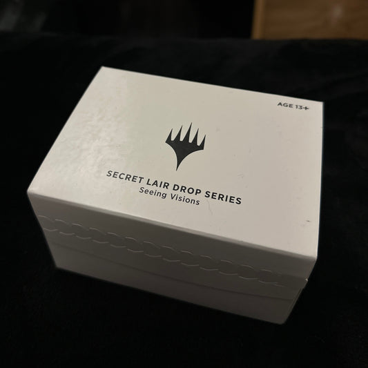 White box with black text and mtg logo on a dark background